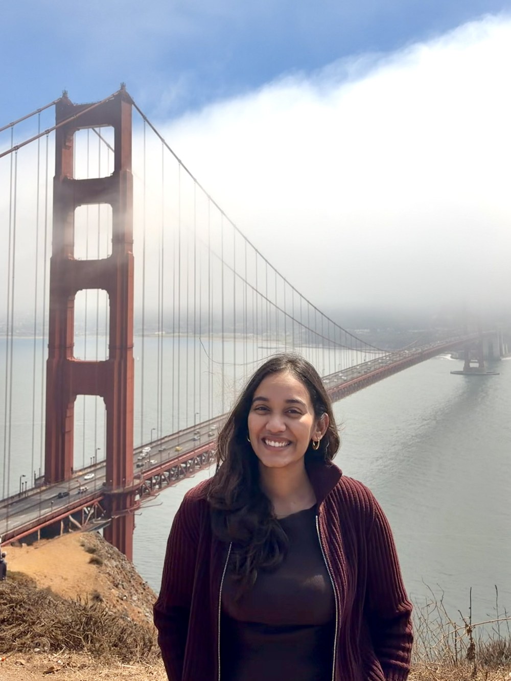 Swati smiling in front of the Golden Gate Bridge